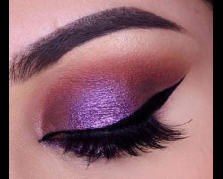 closed eyelid with purple eyeshadow showcasing false eyelashes